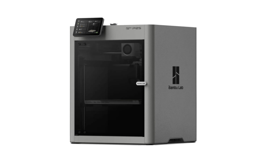 Three-quarter view of the Bambu Lab P2S, a gray enclosed 3D printer with a glass door and a small touchscreen on top.