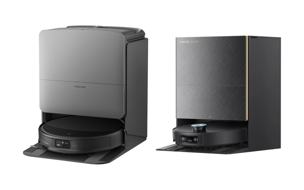 Two robot vacuum docks side by side: a gray Roborock dock with the robot underneath on the left, and a dark Dreame dock with a black robot at its base on the right.